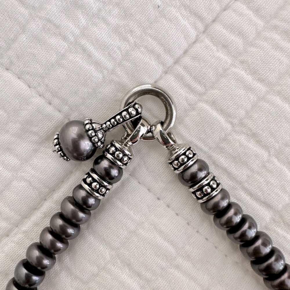 Cultured pearl and silver necklace with charm.